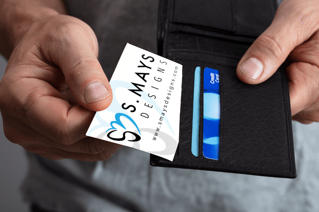 man pulling business card out of wallet